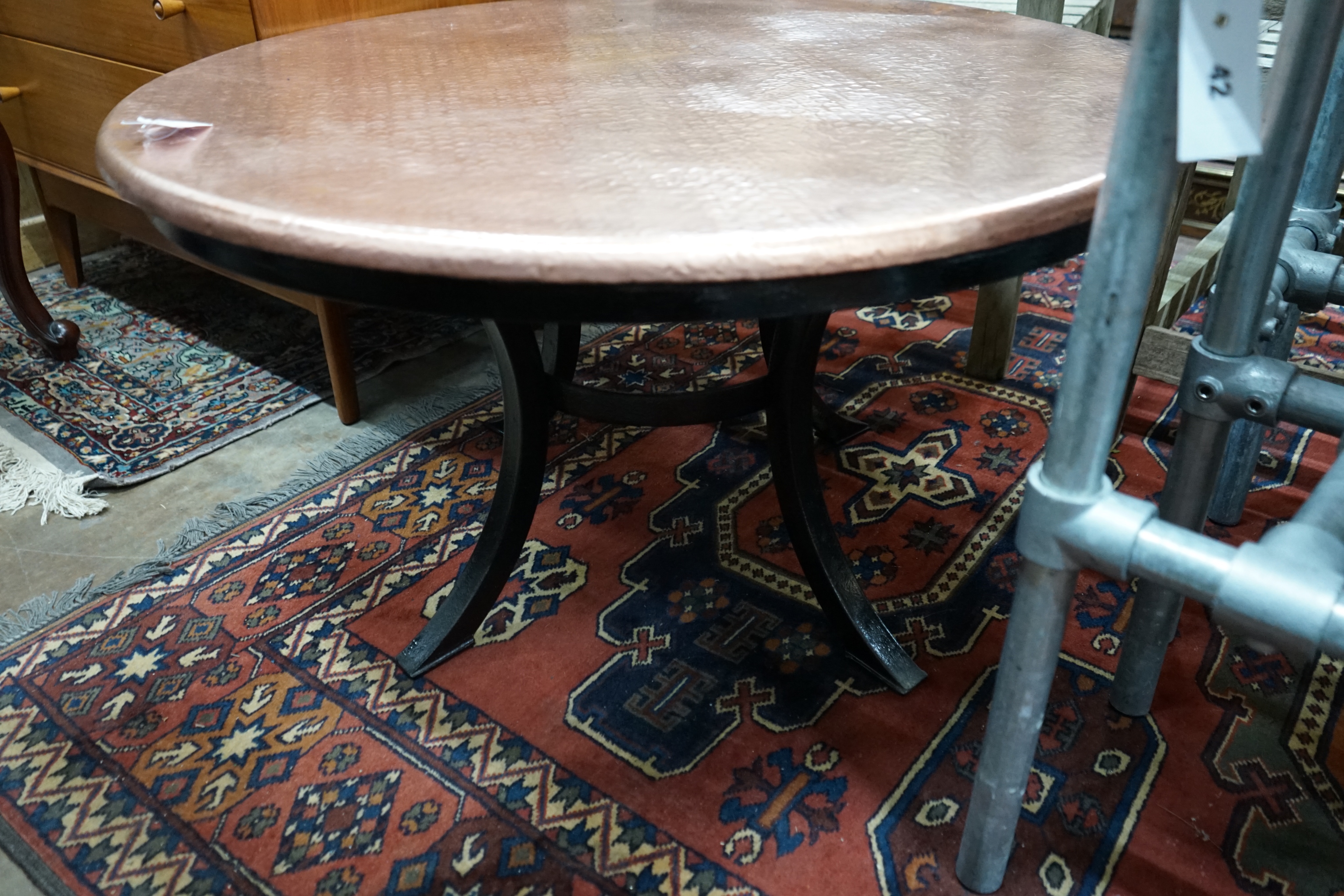 A circular hammered copper and wrought iron low table, diameter 88cm height 49cm